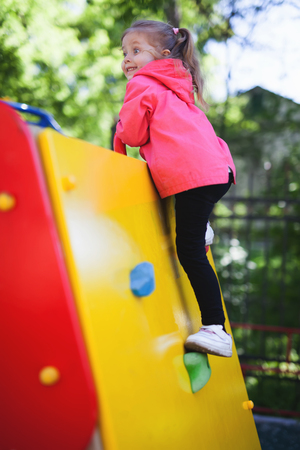 Image of climbing little girl to top of wallの写真素材