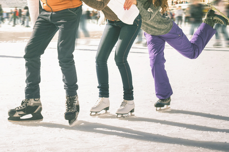 Funny teenagers girls and boy skating outdoor, ice rinkの写真素材