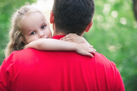 Girl hug her daddy with loveの写真素材