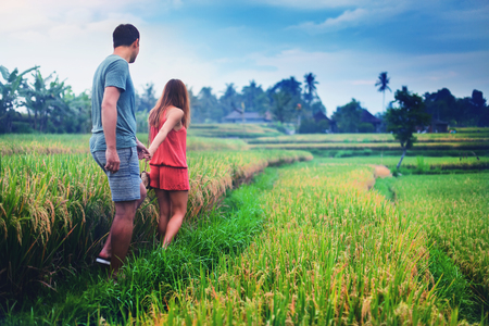 Happy couple walking at the rice terraces. Traveling at Bali.の写真素材