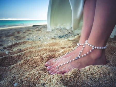 Closeup Decorated Bridal Foots of Beautiful bride at beach, Bali.の写真素材