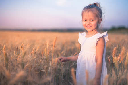 Happy Little Girl Outdoor At Wheat Field. End of Summerの写真素材