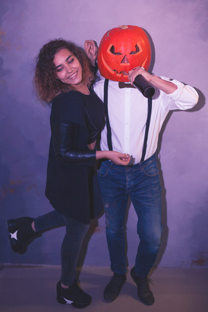 Unusual couple with pumpkin at the Halloween partyの写真素材