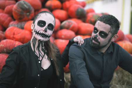 Couple with scary makeup celebrating halloween outdoorの写真素材