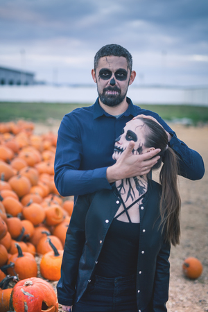 Couple with scary makeup celebrating halloween outdoorの写真素材