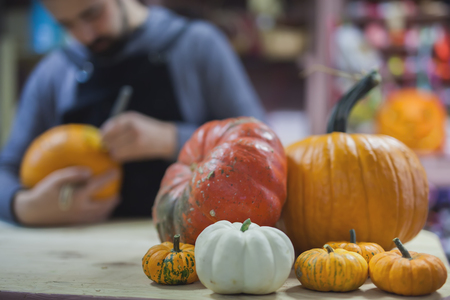 Man carves a pumpkin to decorate the Halloweenの写真素材