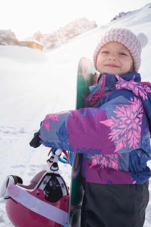 Your happy kid has ski or snowboard lesson at alpine school.の写真素材