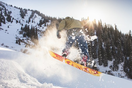 Snowboarder doing his trick one eighty, snowboarding competitionの写真素材