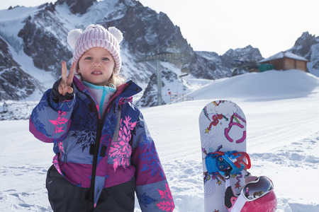 Your happy kid has ski or snowboard lesson at alpine school.の写真素材