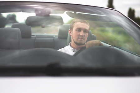 Handsome man drives cabriolet carの写真素材