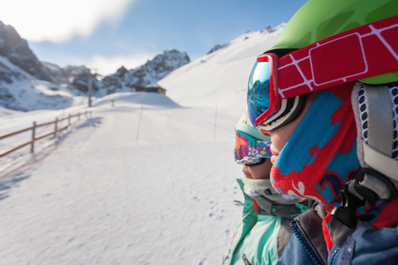 Portrait of child and mom skiing in the mountains.の写真素材