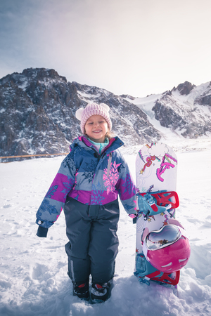 Your happy kid has ski or snowboard lesson at alpine schoolの写真素材
