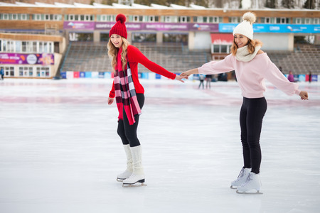 women ice skating outdoor at ice rinkの写真素材