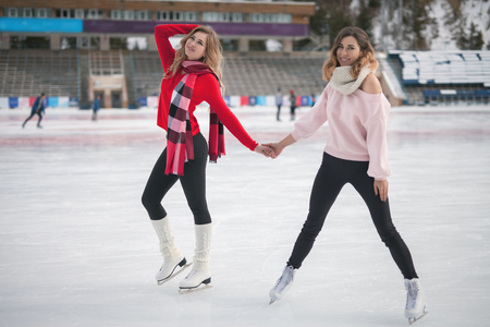 women ice skating outdoor at ice rinkの写真素材