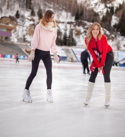 women ice skating outdoor at ice rinkの写真素材