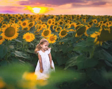 New Era Concept With Happy Kids, People. At Sunflower Fieldの写真素材