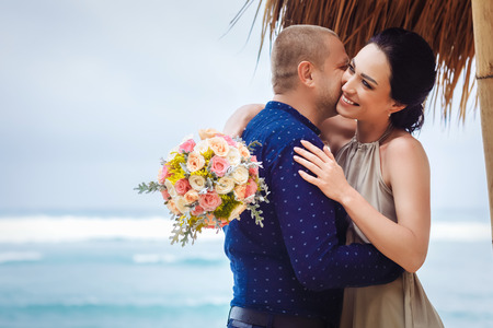 Beautiful couple near the ocean, honeymoon romantic coupleの写真素材