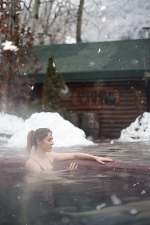 Woman enjoying the panoramic view from the pool in the alpsの写真素材
