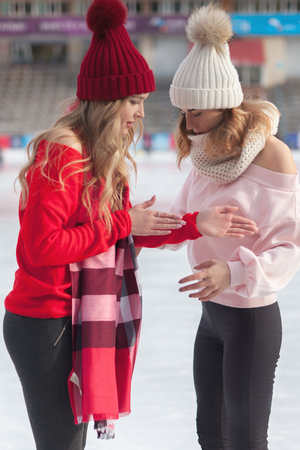 women ice skating outdoor at ice rinkの写真素材