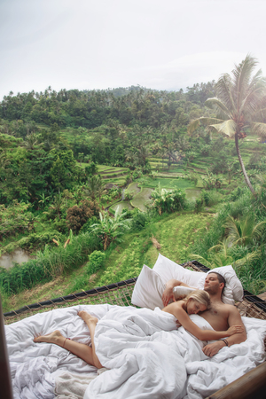 Honeymoon at Bali, Ubud. Successful couple relaxing at villa, beautiful viewの写真素材