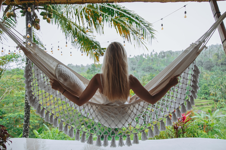 Healthy sleep in the open air at hammock. Sexy woman relaxingの写真素材