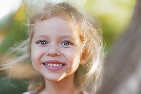 Summer outdoor portrait of beautiful happy child