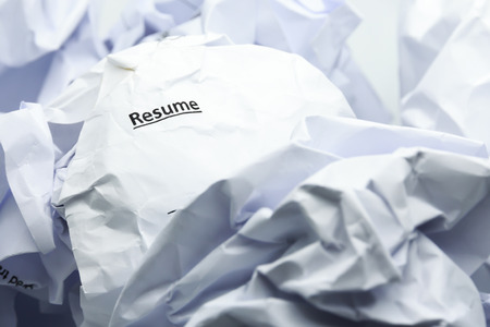 Concept of resume crumpled up and thrown away in the trash.の写真素材