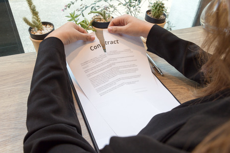 Business Woman ripping up a contract concept.の写真素材