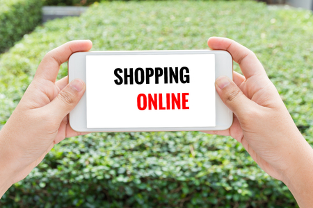 Woman hand holding Cellphone with shopping online wordの写真素材