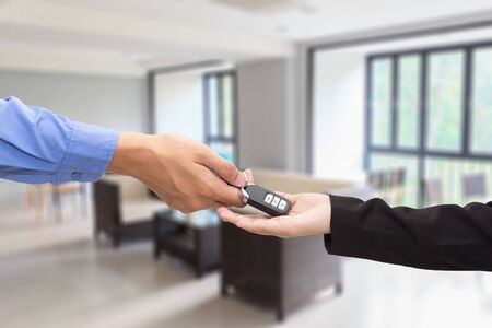Buying Car. Businessman giving a key car to businesswoman concept