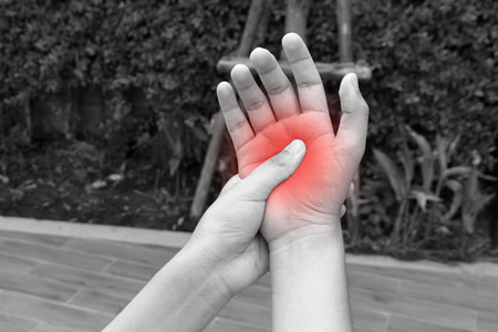 Woman hands pain in public park - black and white conceptの写真素材