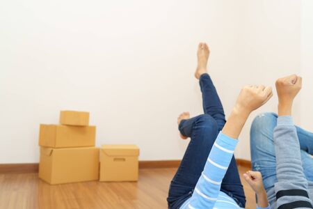 Couple chilling in empty room that ready to move in - buying new house concept.