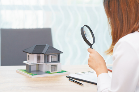 Smile woman searching for new home or inspecting homes before buying conceptの写真素材