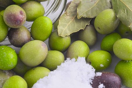 preparation of pickled olives  olives, salt, water and bay leavesの写真素材