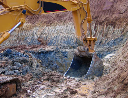 Yellow Excavator at Construction Site to make the preparations for a new buildingの写真素材