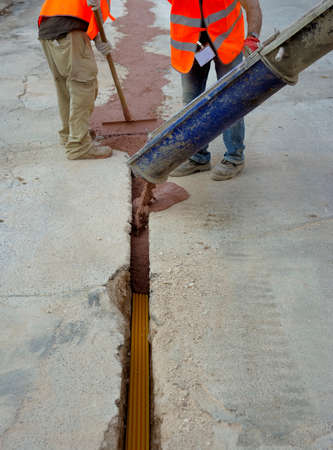 fiber optic cables buried in a micro trench by a workerの写真素材