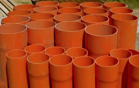 A bundle of red pvc pipes for underground pipelines sewerの写真素材