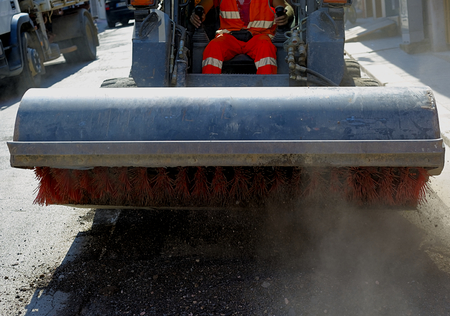 Sweeper attachments mini excavator. The sweeper sweeps, collects and dumps dirt and debris.