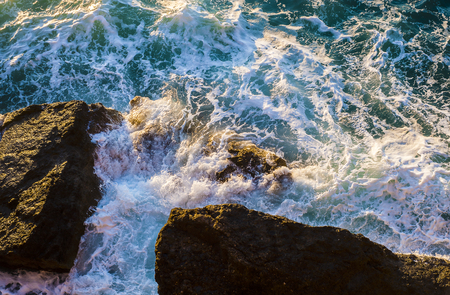 sea foam from a cliff during a stormの写真素材