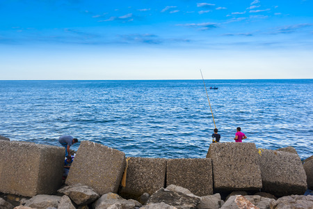 amateur fishermen who fish from the dock in a portの写真素材