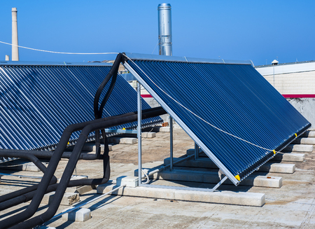 Vacuum solar cells for water heating system on the pool roofの写真素材