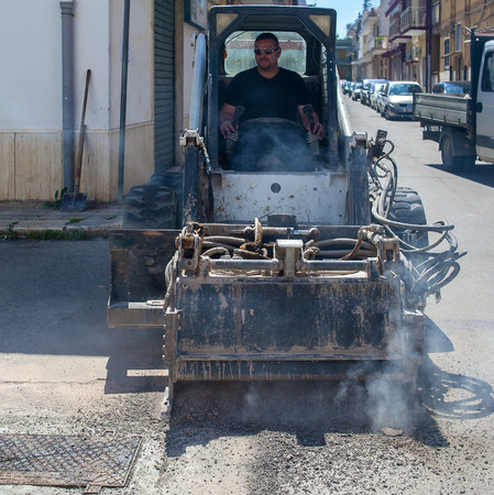 worker driver Skid steer remove Worn Asphalt during repairing Road Worksの写真素材