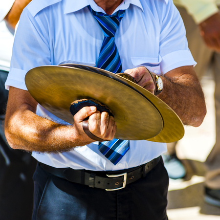 musician plays the cymbals during a religious processionの写真素材