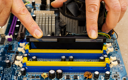 Put computer memory DDR RAM in the slot of motherboardの写真素材