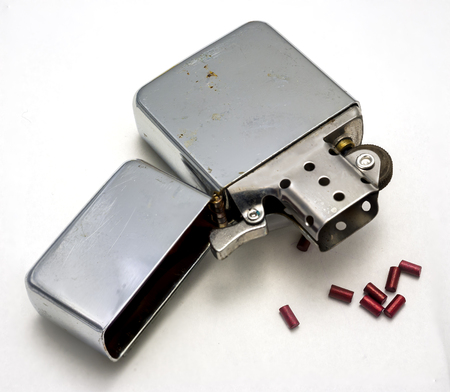 cigarette lighter opened with beads of reserve flint white backgroundの写真素材