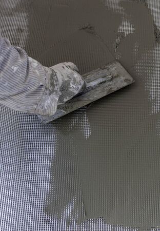 worker plastering tool plaster marble on interior plaster rough.  Selective focus の写真素材