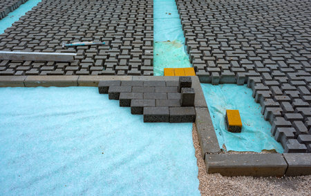 Heap of interlocking paving stones; Material for paving works on sheet of nonwovenの写真素材