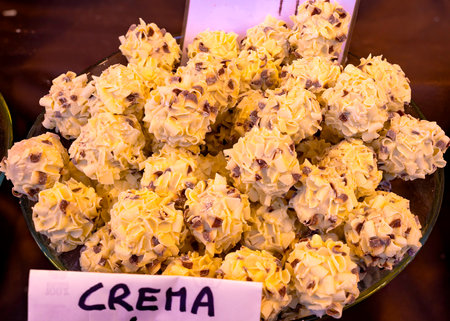 chocolate and cream truffles, beautifully arranged on a chocolate maker's counter during a fair. The word "CREMA" is indicated on the plate. Selective focusの写真素材