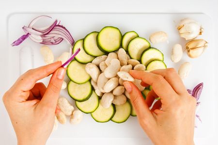 composition of vegetables with your hands on white traysの写真素材