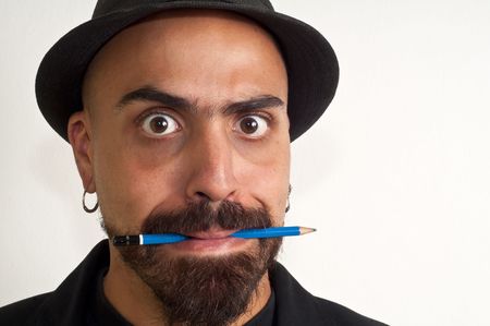 man with a pencil and a hat with funny expression with white backgroundの写真素材